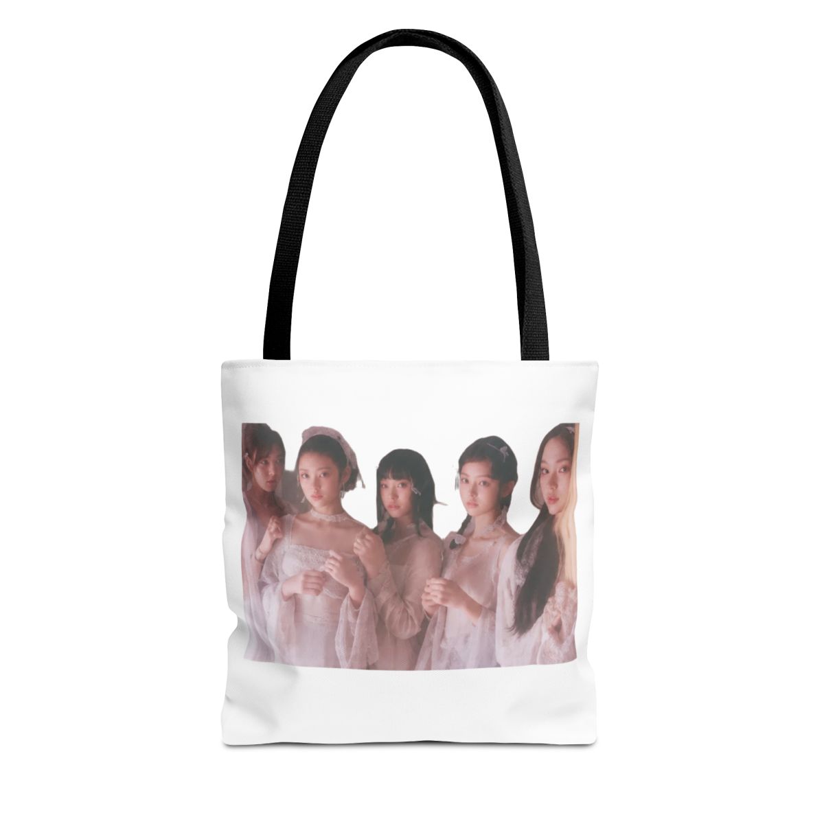 Black Bags with the pink text "NEWJEANS". The bag has a photo of five people. The bottom of the bag has the text "NEWJEANS TOTE" in green - Official Creator merchandise